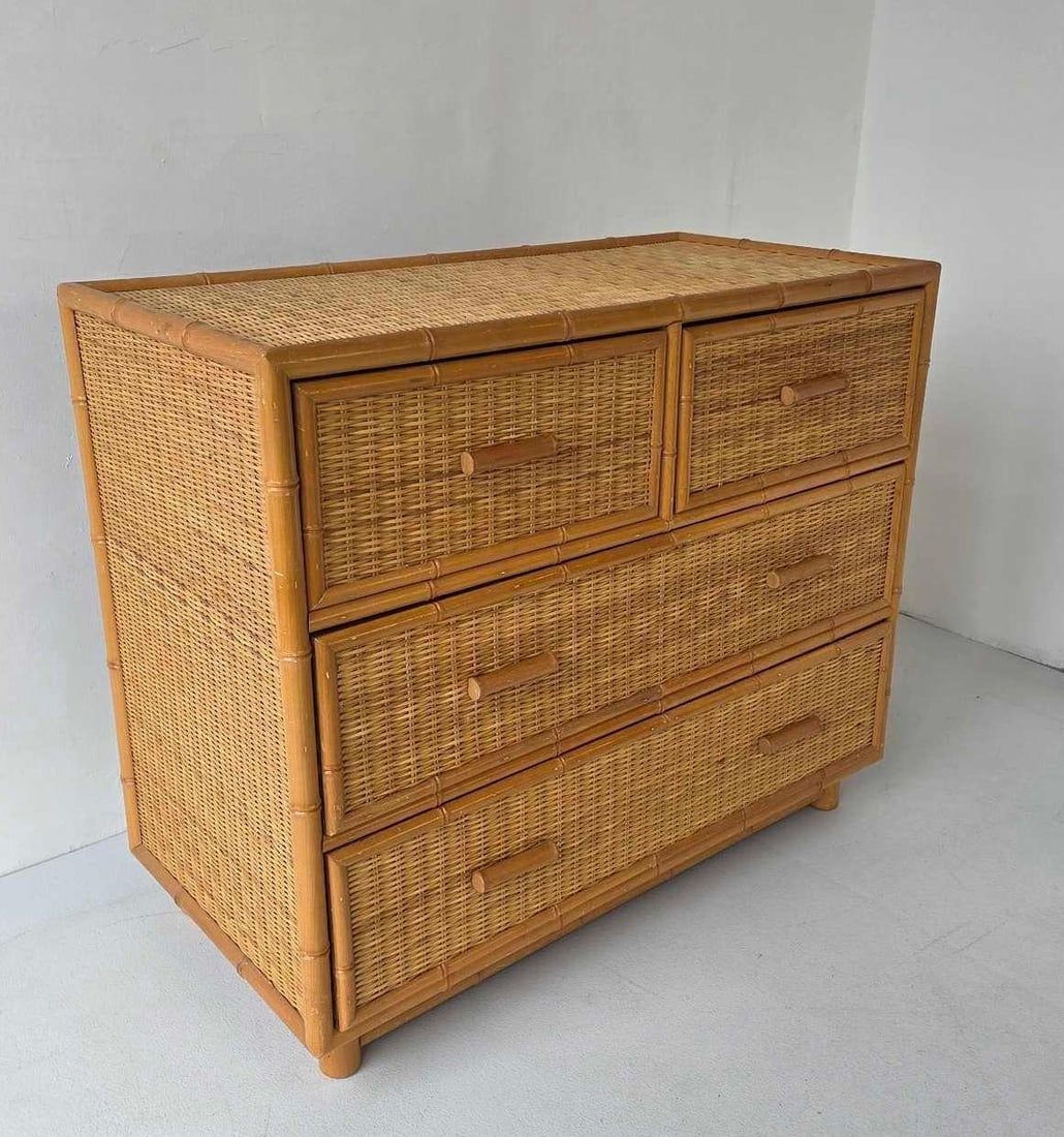 VINTAGE COASTAL STYLE FAUX BAMBOO AND WOVEN RATTAN FOUR-DRAWER CHEST IN THE STYLE OF CRESPI: Mid-century tropical four-drawer commode with honey-toned faux bamboo fretwork and tightly woven rattan paneling. Approximate Dimensions: 30"h x 35.75"w x 18"d Artist or Maker: Unknown
