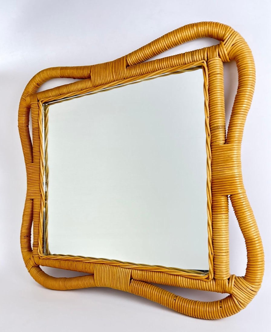 VINTAGE RATTAN WRAPPED SCULPTURAL WALL MIRROR: Mid-century modern style mirror featuring a thick, undulating frame of tightly wrapped natural rattan with decorative open-loop corners and a square glass center. Approximate Dimensions: