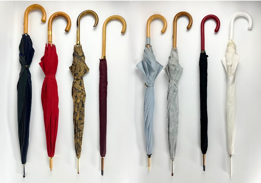 LUXURY COLLECTION OF EIGHT VINTAGE DESIGNER UMBRELLAS HERMÈS VERSACE COURREGES: A lot of various vintage luxury brand umbrellas including 2 Hermes Umbrellas, Courreges, Doppler, Versace. Longest Dimensions: 40"L x 45"DIA Maker: Various Provenance: A prominent NYC Retai