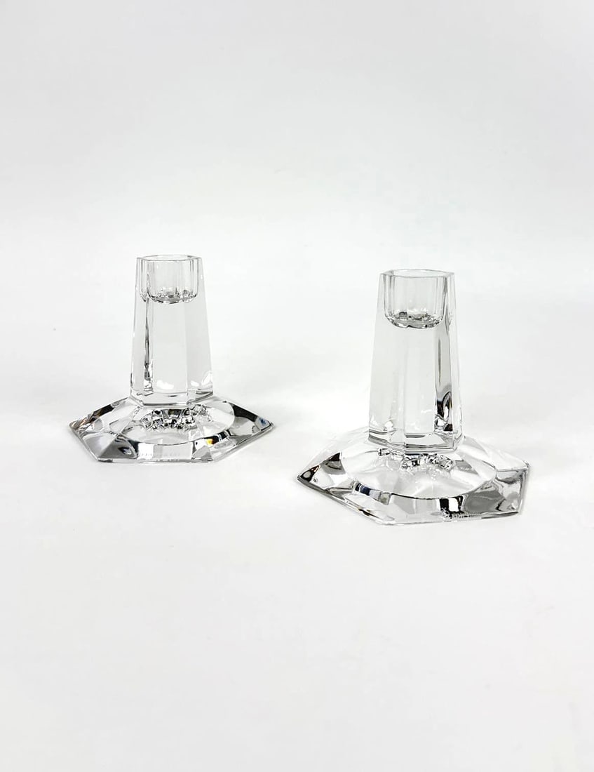PAIR OF TIFFANY & CO FRANK LLOYD WRIGHT CRYSTAL CANDLESTICKS: A pair of art deco style crystal candle holders with hexagonal stepped bases and faceted pillars from the Frank Lloyd Wright Foundation collection. Approximate Dimensions: 3.75”H x