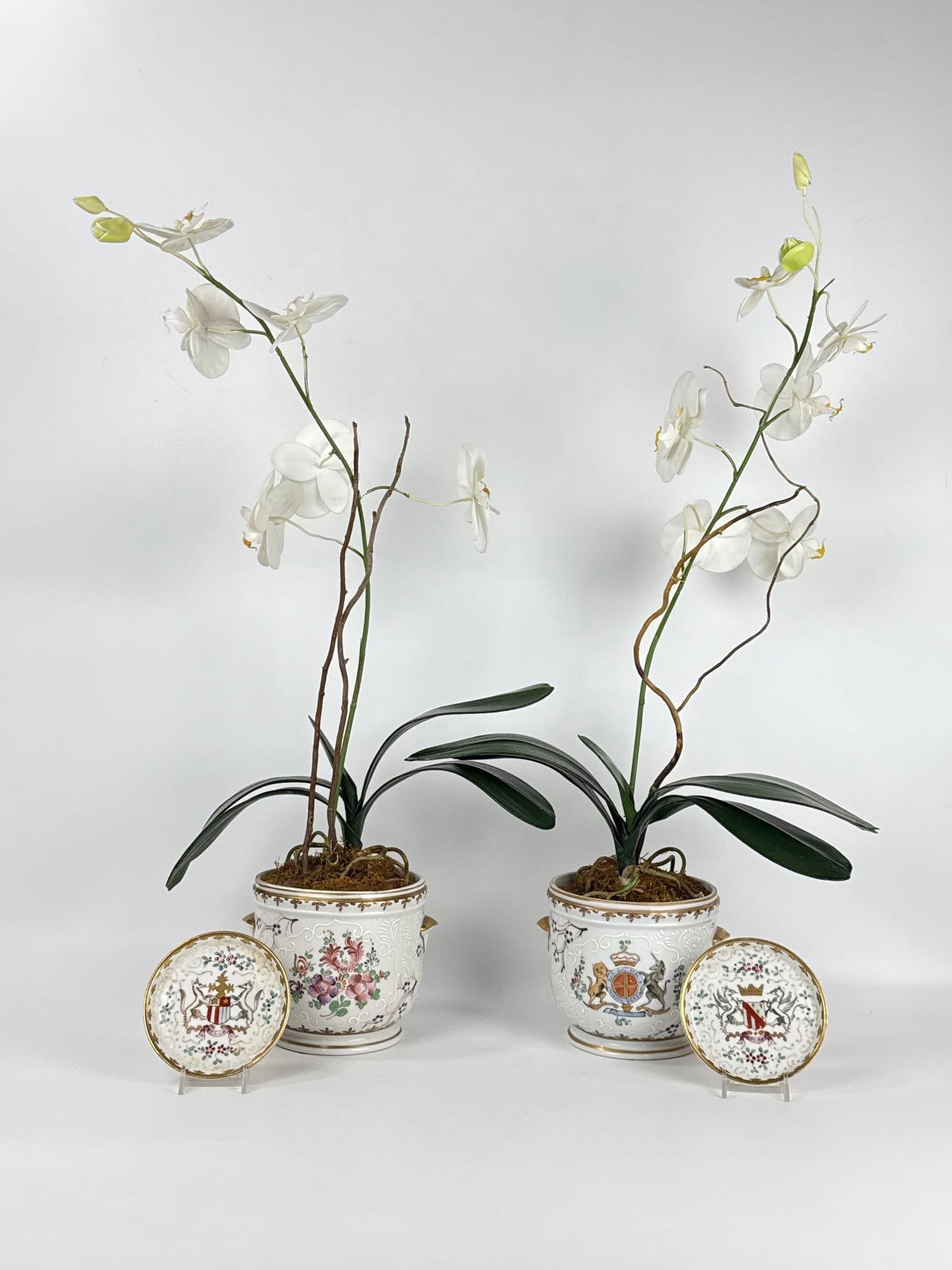 PAIR OF SAMSON, SEVRES STYLE ARMORIAL PORCELAIN CACHEPOTS AND MATCHING PLATES: Late 19th-century French hard-paste porcelain vessels and dishes decorated with polychrome heraldic crests and white slip bianchi-sopra-bianco scrolls. Approximate Dimensions: 5.25”h x 6”