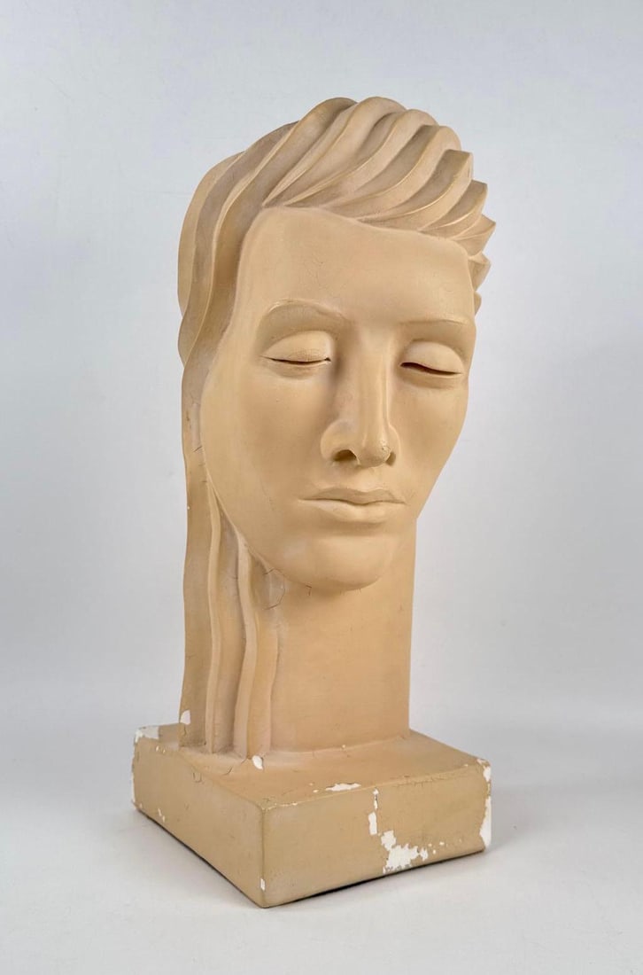 MILANO DESIGNS AFTER LORA MARX VINTAGE DECO BUST FEMALE: Stylized cast composite female head sculpture with a sleek monochromatic finish on a tiered square pedestal base. Approximate Dimensions: 18.5"h; Base 7" Artist or Maker: Milano Designs Afte