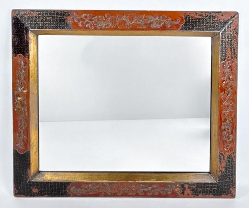 ANTIQUE CHINOISERIE RED LACQUER AND GILT WALL MIRROR: An 18th-century style rectangular looking glass with a hand painted cinnabar and black japanned frame with floral gilt scrolls. Approximate Dimensions: 21"h x 25"w Artist or Maker: Unknown