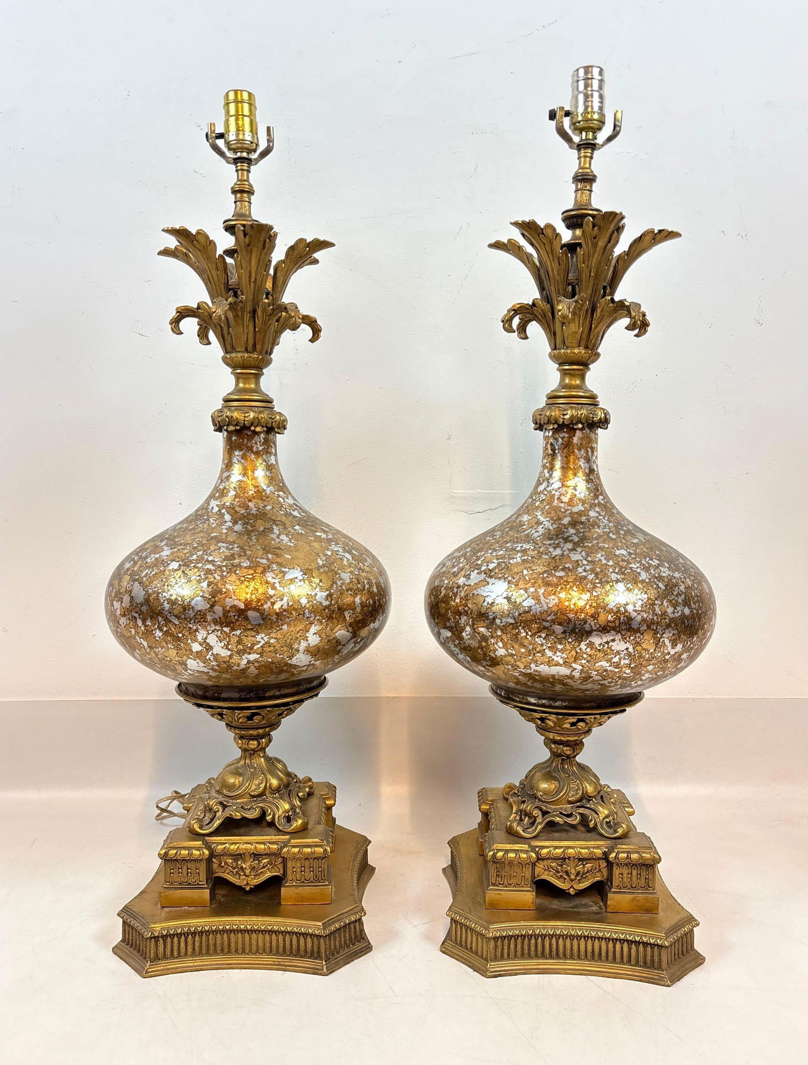 PAIR OF VINTAGE HOLLYWOOD REGENCY GOLD SILVER SPECKLED TABLE LAMPS: **A vintage set of Hollywood Regency style "genie bottle" or urn shaped table lamps with speckled gold and silver finished bodies and ornate brass stems and bases in Carl Falkenstein style. Ap