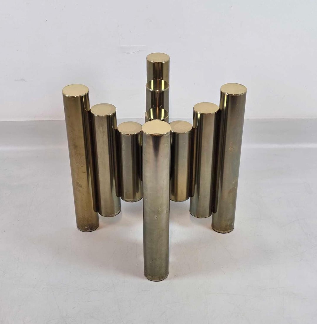 TIM BATES FOR PIEFF ENGLAND BRASS CYLINDER COFFEE TABLE (1 OF 2): *Bundled brass cylinder pedestal base with a beveled glass Approximate Dimensions: 20.5"h x 15"w x 16"d Artist or Maker: Pieff England Provenance: From a New York Collector Notes: Althoug
