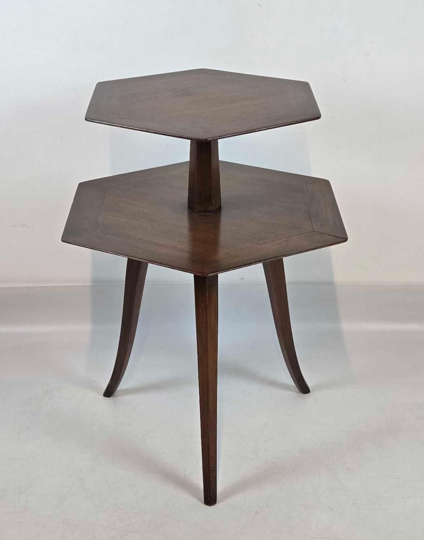 VINTAGE EDWARD WORMLEY FOR DUNBAR TWO TIER MAHOGANY SIDE TABLE: *Mid-century sculptural mahogany end table featuring a distinct two-tier silhouette with splayed tripod legs and early metal manufacturer label. Approximate Dimensions: 30"h x 21.75"w x 25"