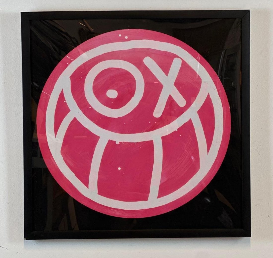 ANDRE SARAIVA PINK MR A ON BLACK BACKGROUND 2012 ARCHIVAL INKJET ON PAPER 35/50 SIGNED: *Pink round Mr. A character with "OX" eyes on black square background Approximate Dimensions: 20" X 20"; FRAME: 21" X 21" Artist or Maker: Andre Saraiva Provenance: From a New