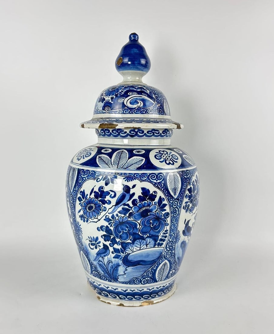 RARE 1700 DELFT BLUE & WHITE BALUSTER TEMPLE JAR WITH COVER: *Antiquarian tin-glazed earthenware vessel with four floral panels and acorn finial lid Approximate Dimensions: 18" h x 8.5" dia Artist or Maker: Unknown Provenance: From a New York Museum'