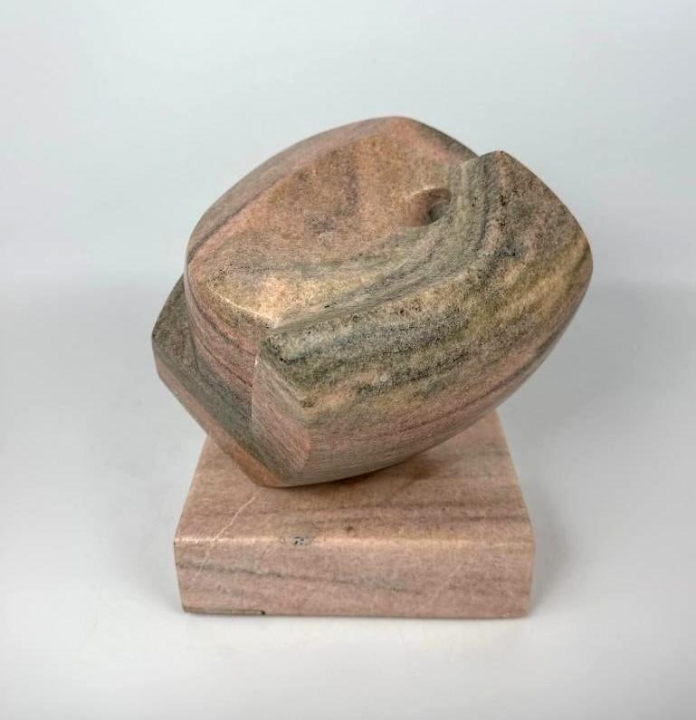 MODERNIST SIGNED PINK MARBLE ABSTRACT SCULPTURE BY EDWARD J. MARTIN: *A biomorphic hand carved banded pink and grey marble abstract form on a stone plinth by Edward J. Martin. Approximate Dimensions: 10” h x 9.5” w x 9.5” d Artist or Maker: Edward J