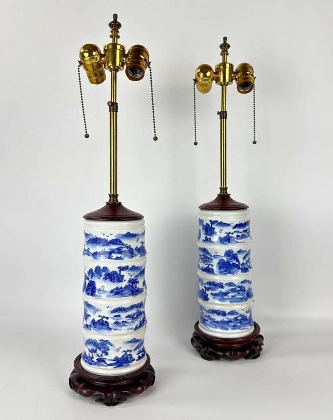 PAIR OF CHINESE BLUE AND WHITE PORCELAIN CYLINDER VASE TABLE LAMPS: Two vintage Chinese porcelain table lamps with blue and white mountain landscape scenes on bamboo-form cylinder bases. Approximate Dimensions: 26”h x 5.5”dia Artist or Maker: Unknown 