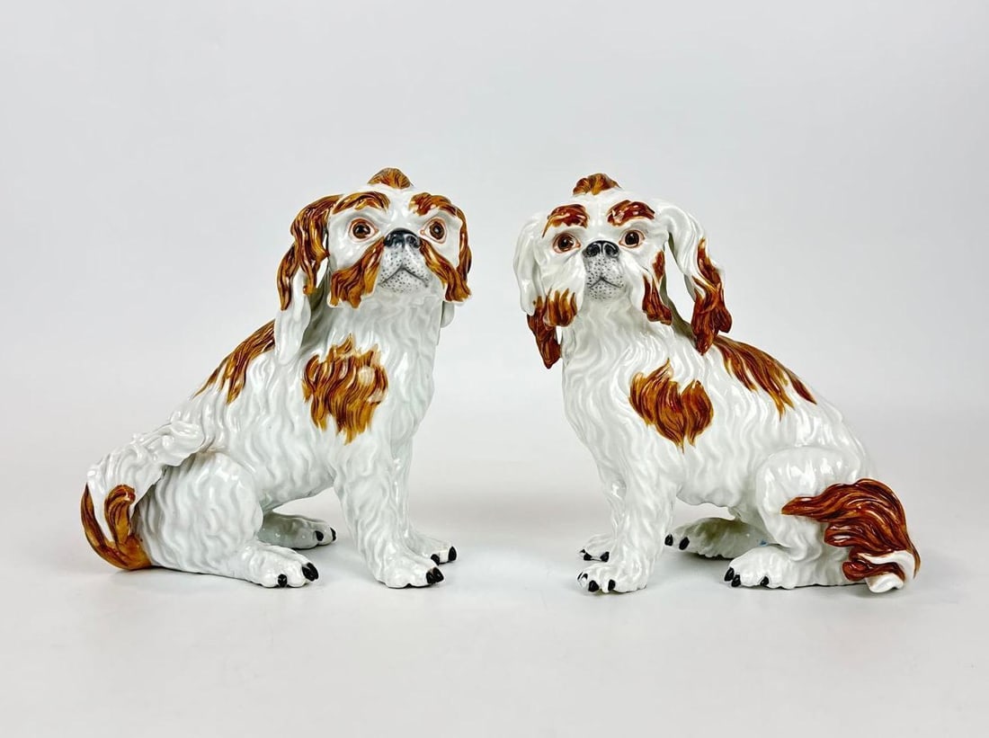 PAIR OF 19TH CENTURY ANTIQUE MEISSEN PORCELAIN SHIHTZU DOG FIGURINES: Fine pair of 19th-century Meissen porcelain seated Cavalier King Charles Spaniel or Shis tzu dogs with hand-painted russet patches and detailed molded fur. Approximate Dimensions: 6”h x 5.75w x