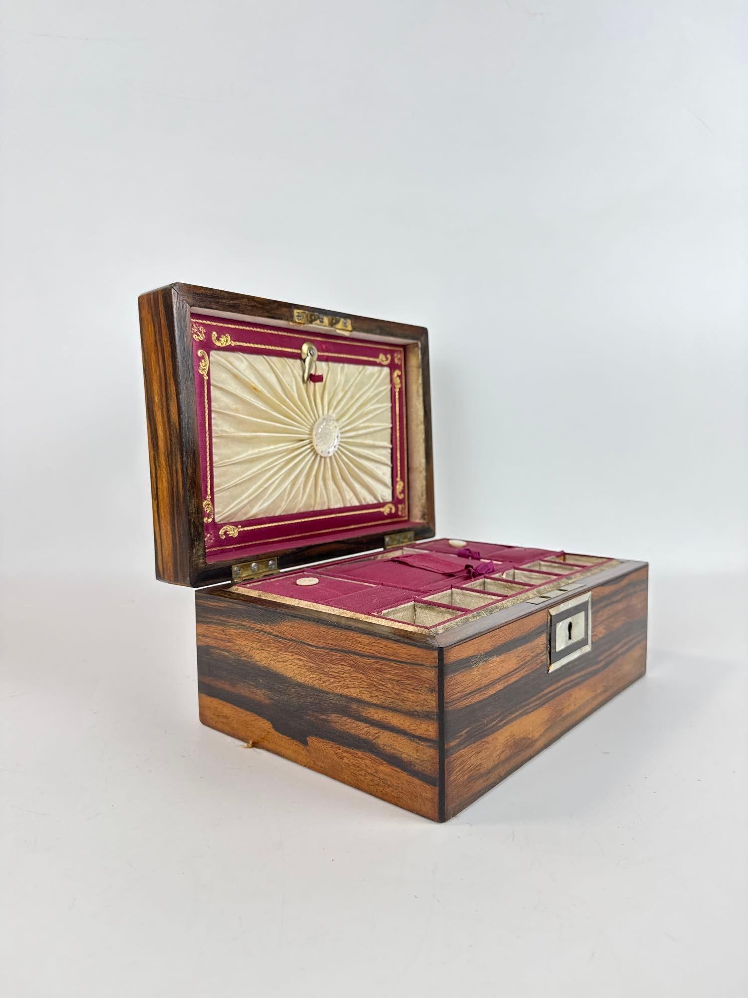 ANTIQUE VICTORIAN ROSEWOOD AND MOTHER OF PEARL INLAID JEWELRY BOX: 19th-century rectangular hardwood casket with intricate scrolling abalone foliate inlay and centered mother-of-pearl cartouche. Approximate Dimensions: 4.5”h x 8.75”w x 7”d Artist or