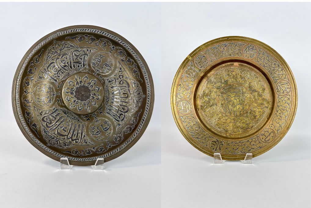 PAIR OF ANTIQUE CAIROWARE/SYRIAN SILVER AND COPPER INLAID BRASS CHARGERS: Matched set of late 19th or early 20th-century Middle Eastern mixed-metal wall plaques featuring intricate hand-chased foliate scroll work and Islamic calligraphy in silver and copper overlay. Approxi