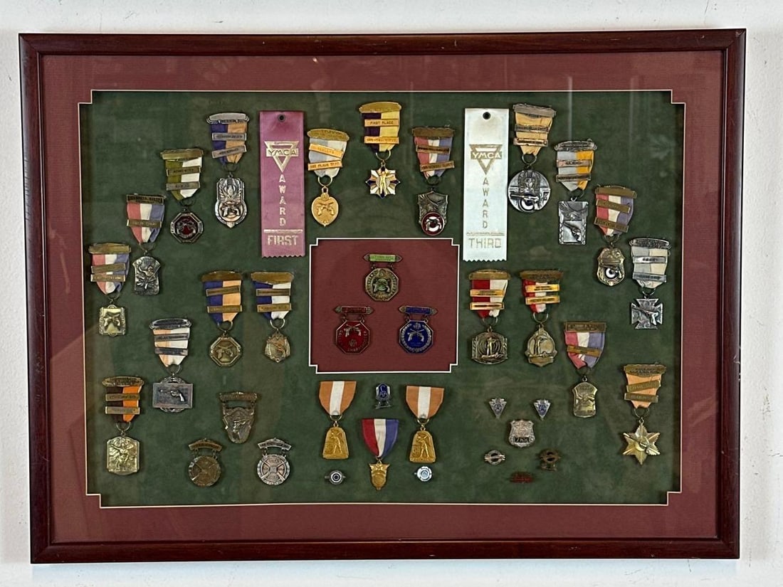 VINTAGE RIFLERY COMPETITION RIBBON & MEDAL COLLECTION IN DISPLAY CASE: A professionally mounted collection of vintage riflery and marksmanship ribbons, featuring prominent awards from the National Rifle Association (NRA), New Jersey State Rifle Association (NJSRA), and