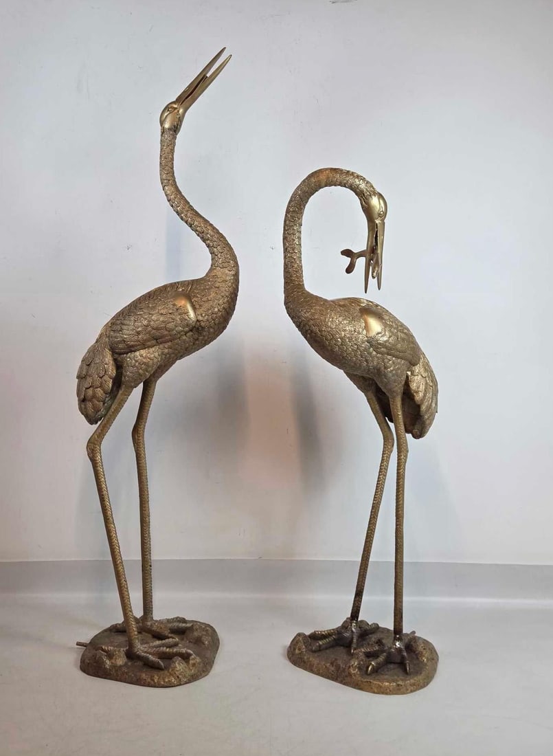 PAIR OF LIFE SIZE BRONZE CRANE GARDEN FOUNTAINS BY BRONZE ELITE BY HENRI: Pair of large-scale patinated bronze garden sculptures plumbed for fountain use. Approximate Dimensions: 70"h x 18.5"w x 22"d and 57"h x 19"w x 23"d Artist or Maker: Elite by Henri