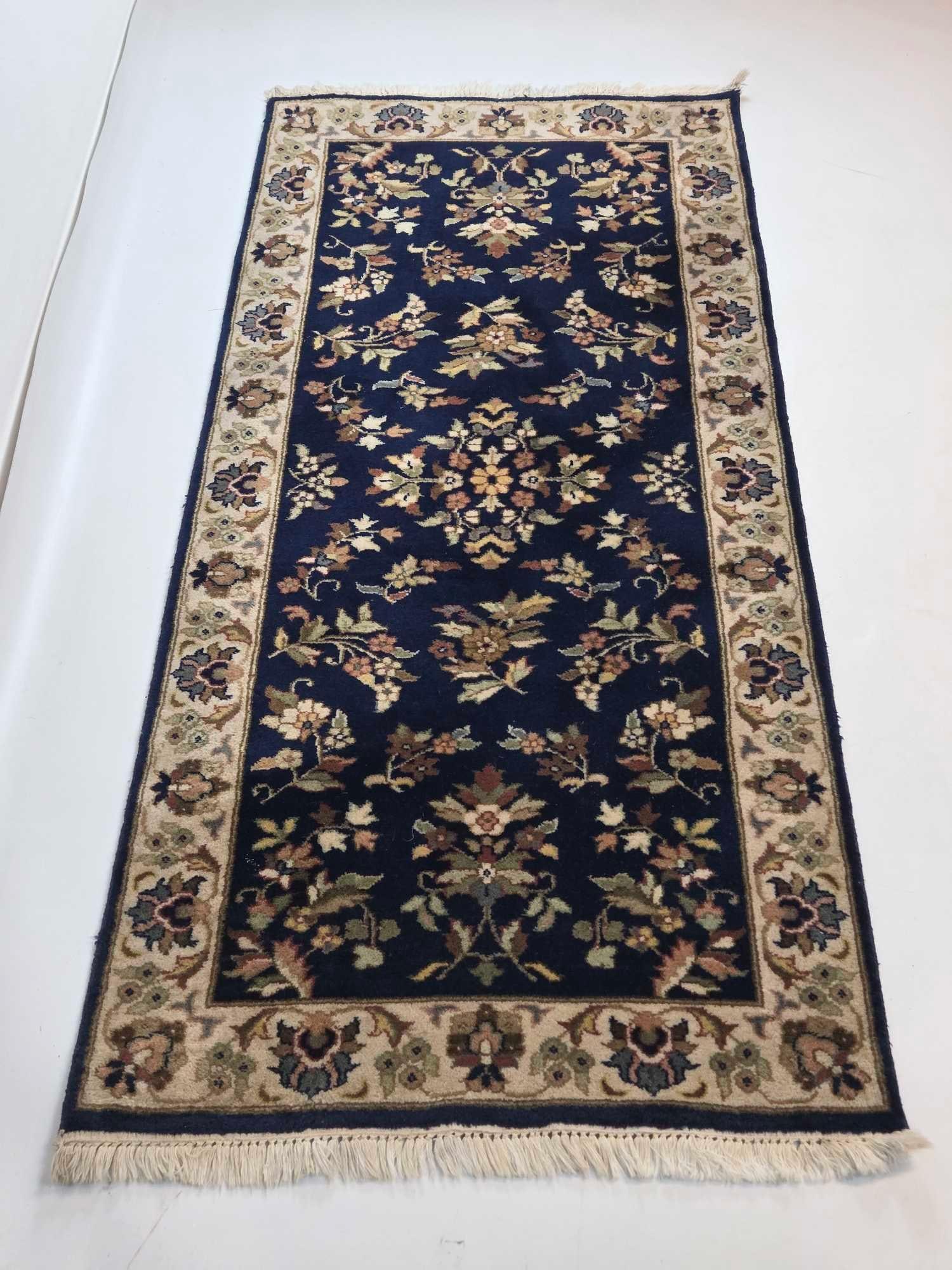 ORIENTAL STYLE WOOL RUNNER WITH FLORAL MOTIF: *Decorative floor runner with floral central field and ivory palmette border Approximate Dimensions: 2'-7" x 6' Artist or Maker: Unknown Provenance: From a New York Collector Notes:</