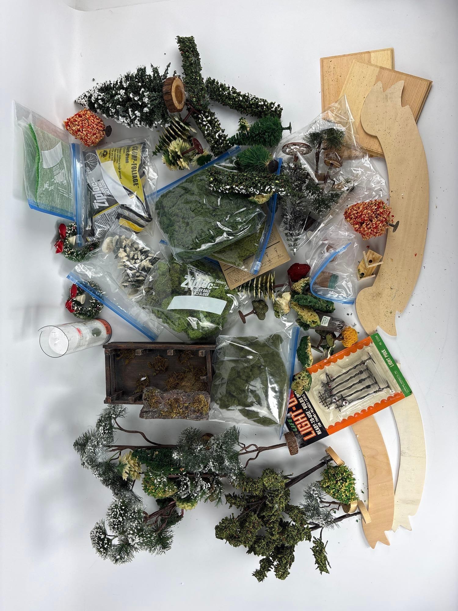 TRAIN SET DECOR VINTAGE CHRISTMAS VILLAGE MODEL SCENERY & MINIATURE LANDSCAPING LOT: *Extensive collection of over 40 miniature landscaping pieces including flocked evergreen trees, deciduous fall foliage, moss ground cover, and model light poles. Approximate Dimensions: various Arti