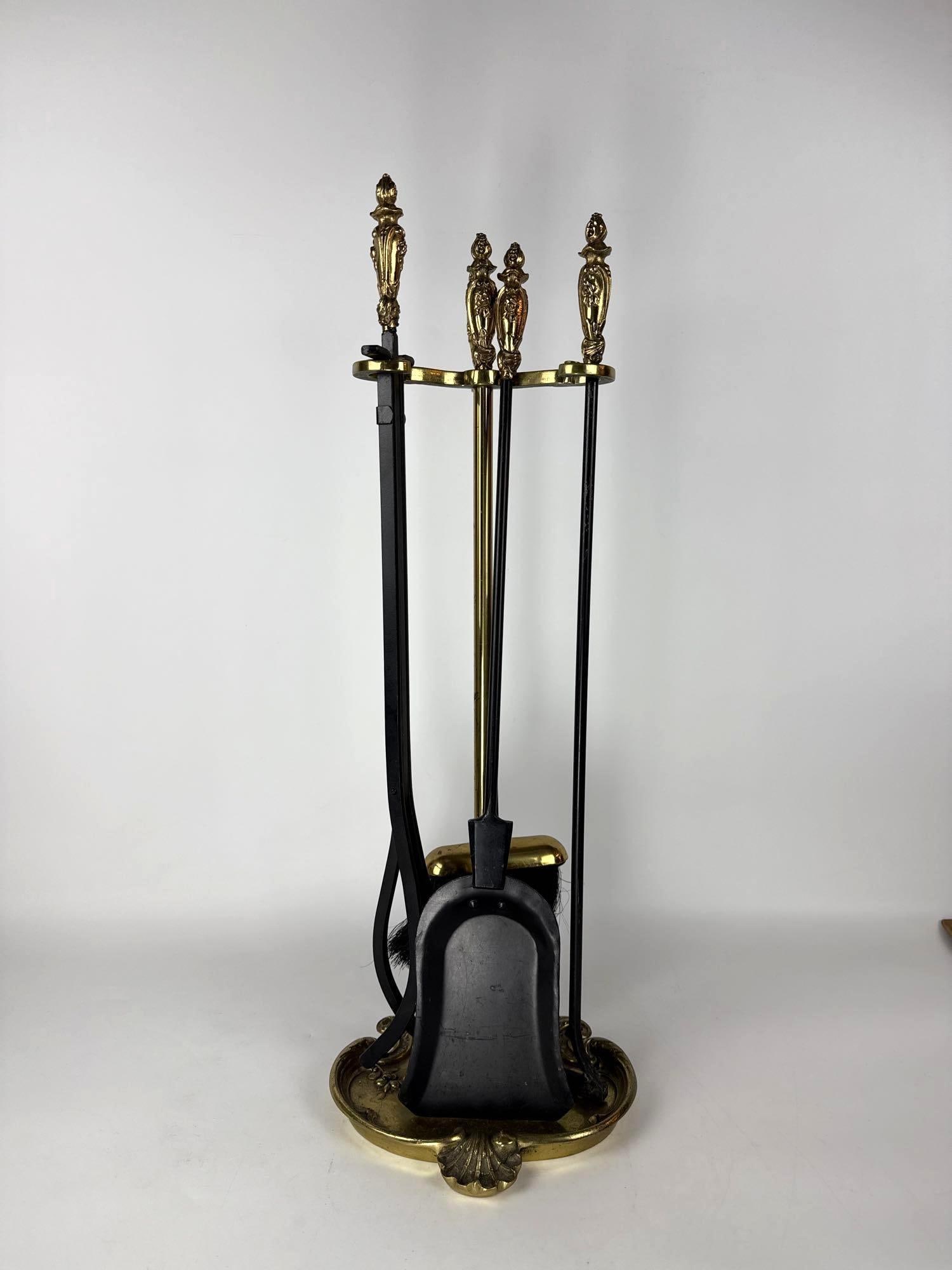 VINTAGE ORNATE BRASS AND BLACK IRON 5-PIECE FIREPLACE TOOL SET: **Decorative finial cast iron fireplace tool set - 5 pc set Approximate Dimensions: 31.5”h x 9.5”w x 8.5”d Artist or Maker: Unknown Provenance: From a New York Collector Notes: