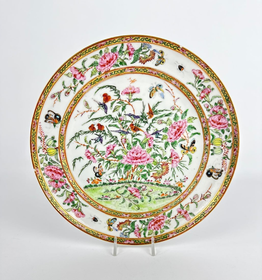 ANTIQUE CHINESE EXPORT PORCELAIN PLATE IN FAMILLE ROSE THOUSAND BUTTERFLY PATTERN: Large 19th-century hand-painted charger decorated with vibrant peonies, exotic birds, and butterflies within a gilded cell-border rim. Approximate Dimensions: 9.5”dia Artist or Maker: Unknown Pr