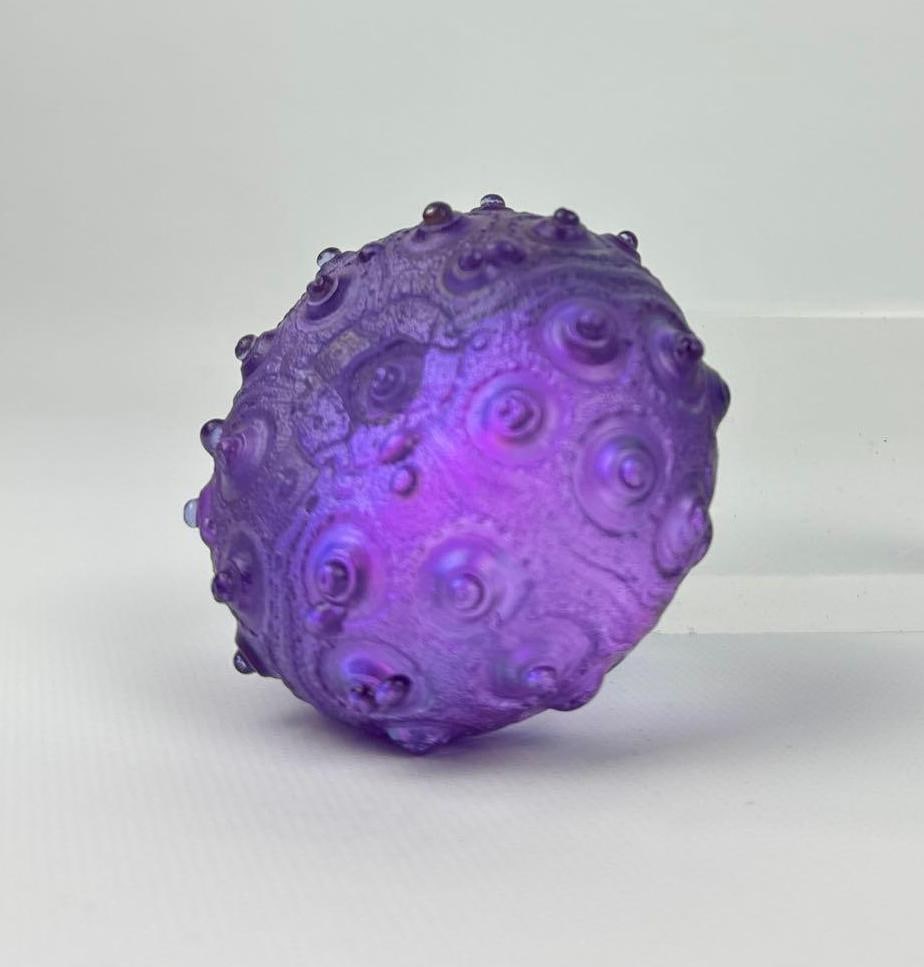 SIGNED DICHROIC IRIDESCENT GLASS SEA URCHIN PAPERWEIGHT: Hand-blown frosted purple art glass sculpture with textured relief and metallic luster. Approximate Dimensions: 1.75”h x 2.75”dia Artist or Maker: Unknown Provenance: From