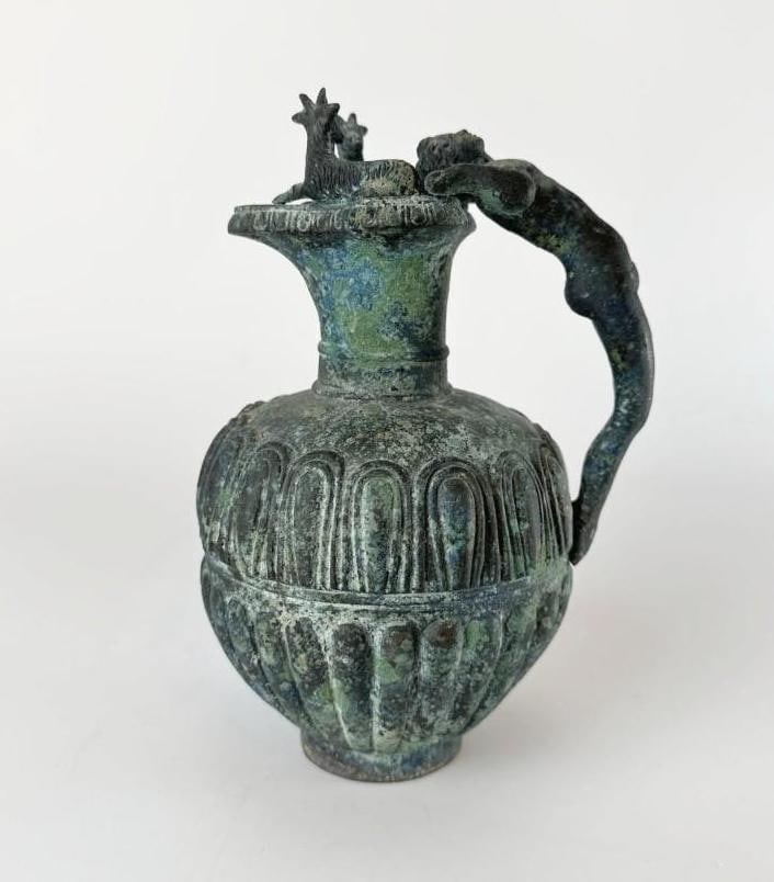 19TH CENTURY FRENCH GRAND TOUR PATINATED BRONZE OINOCHOE PITCHER: Antique patinated bronze wine jug based on classical Greek forms with a arching human figure as handle. Approximate Dimensions: 7.25"H x 5"W x 4.25"Dia Artist or Maker: Unknown Provenan