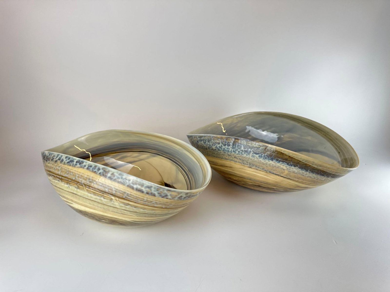 PAIR OF YALOS MURANO ATTR. ART GLASS BOWLS SIGNED: Two vintage Italian art glass bowls with creamy yellow exterior and blue mottled interior swirl patterns in contemporary organic shapes. Largest Approximate Dimensions: 6"H x 16"W x 11"D