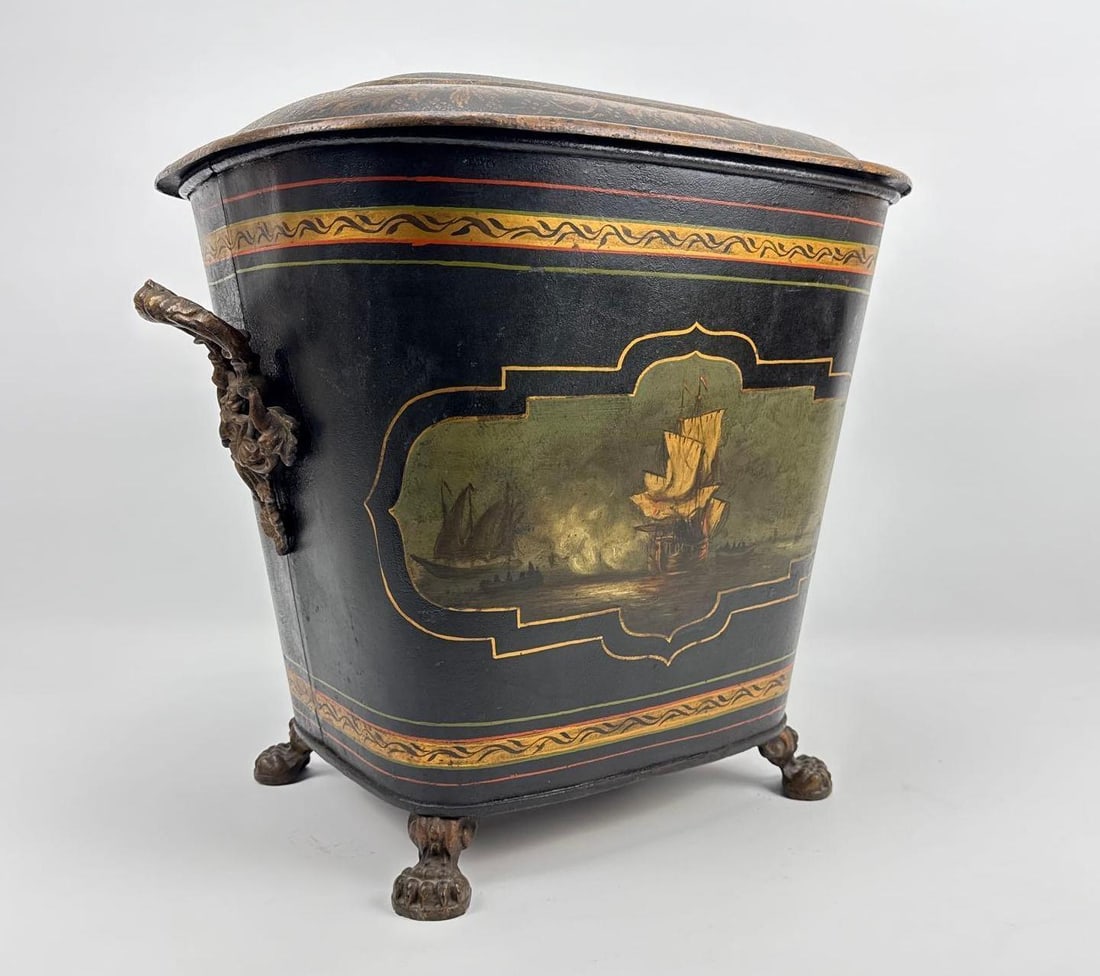 ENGLISH SCHOOL ANTIQUE HAND-PAINTED TOLEWARE FIRESIDE COAL OR WOOD BIN: Large 19th century black lacquered metal hearth bin decorated with a hand-painted maritime scene of sailing ships on cast lion paw feet and ornate side handles. Approximate Dimensions: 18"h x 19&#