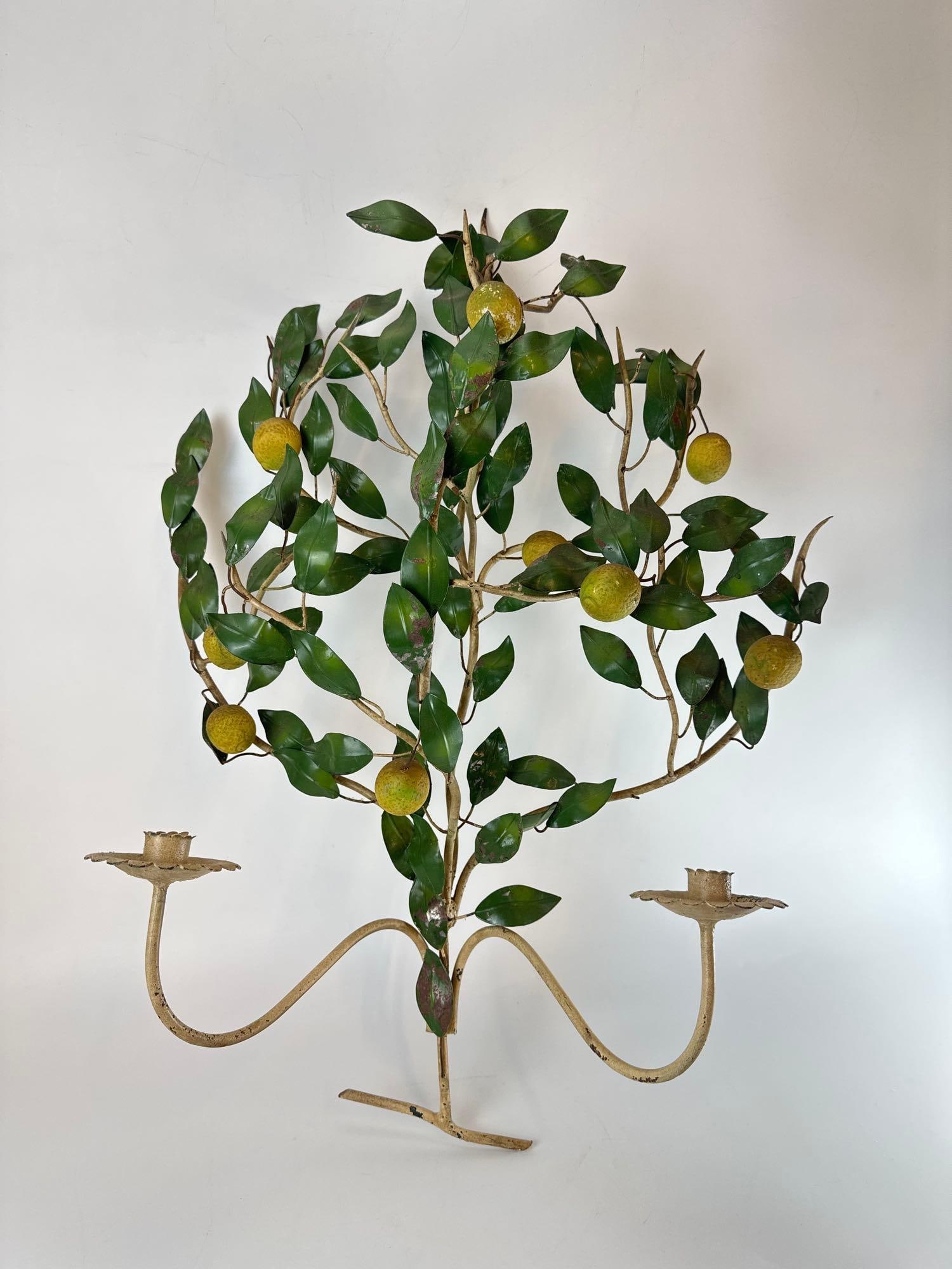 VINTAGE ITALIAN TOLEWARE LEMON TREE TWO-LIGHT WALL SCONCE: Hand-painted wrought iron botanical candelabra with green foliage and yellow citrus fruits Approximate Dimensions:30”x20”x8” Artist or Maker: Unknown Proven