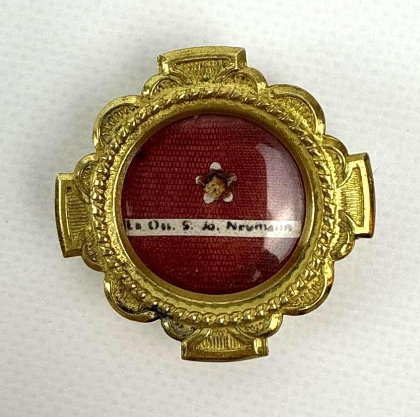 FIRST CLASS RELIC OF ST. JOHN NEUMANN: A gold-toned metal reliquary featuring a first-class relic of Saint John Neumann, likely ex ossibus (from the bone). Approximate Dimensions: 1.75” x 1.75” x .75” Artist or Maker: Unk