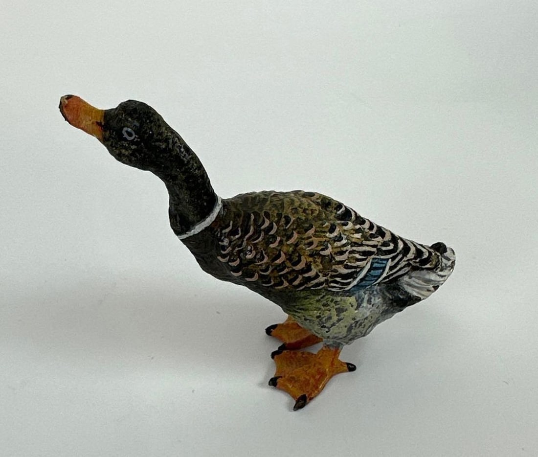 MINIATURE VINTAGE CAST BRONZE DUCK FIGURINE: *Small-scale solid cast bronze or heavy brass sculpture of a waterfowl (duck or teal) in a resting pose, featuring a deep verdigris or aged chocolate patina and simple, stylized anatomical detailing. 