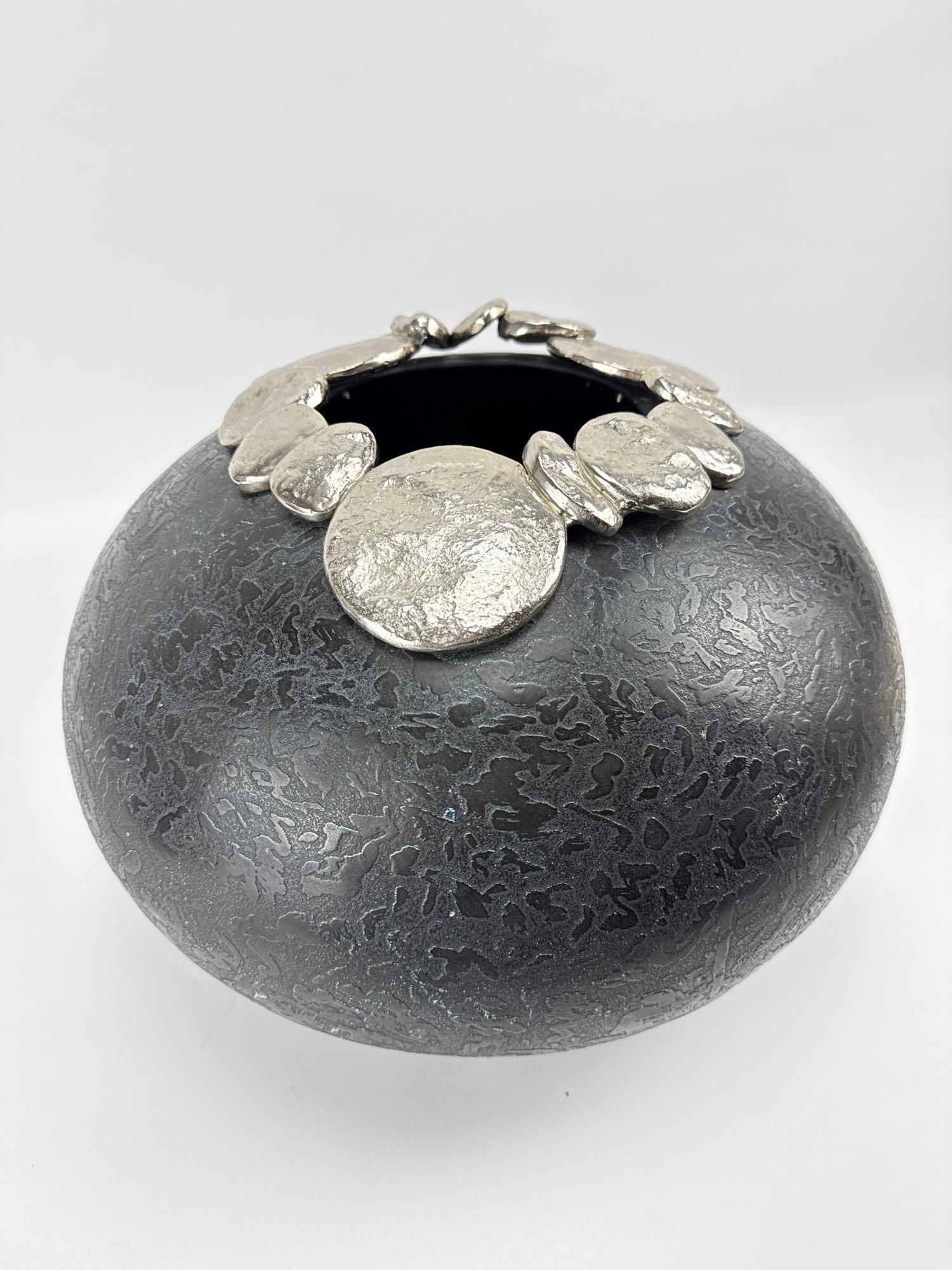CONTEMPORARY STUDIO POTTERY PEBBLE VASE: Large globular ceramic vessel with textured charcoal glaze and a rim decorated with silver-finished relief pebbles. Approximate Dimensions: 10.5”h x 14.5”dia Artist or Maker: Unknown
