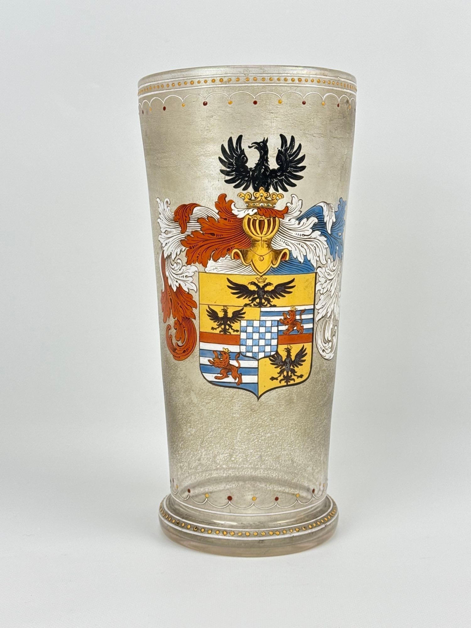 MOSER KARLSBAD ENAMELLED GLASS HERALDIC "ADLER" VASE: Large tapered cylindrical vessel in frosted/satin glass featuring an intricate hand-painted polychrome coat of arms. Approximate Dimensions: 11”h x 5”dia Artist or Maker: Moser Karlsbad