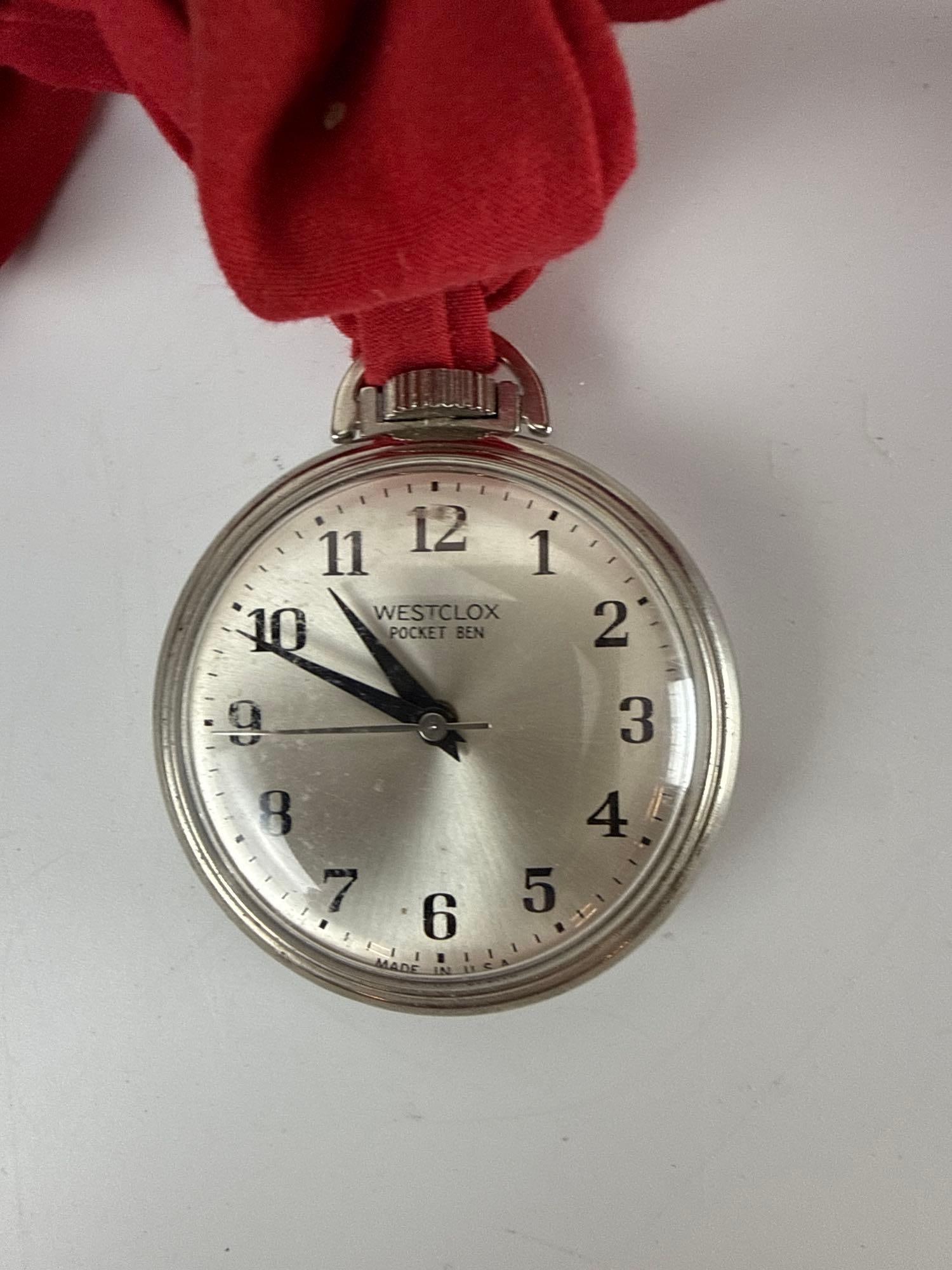 WESTCLOX POCKET BEN VINTAGE MECHANICAL POCKET WATCH MADE IN USA: Classic American-made open-face silver-tone pocket watch with a sunburst dial and bold Arabic numerals. Approximate Dimensions: 2" DIAMETER Artist or Maker: Westclox Provenance: F