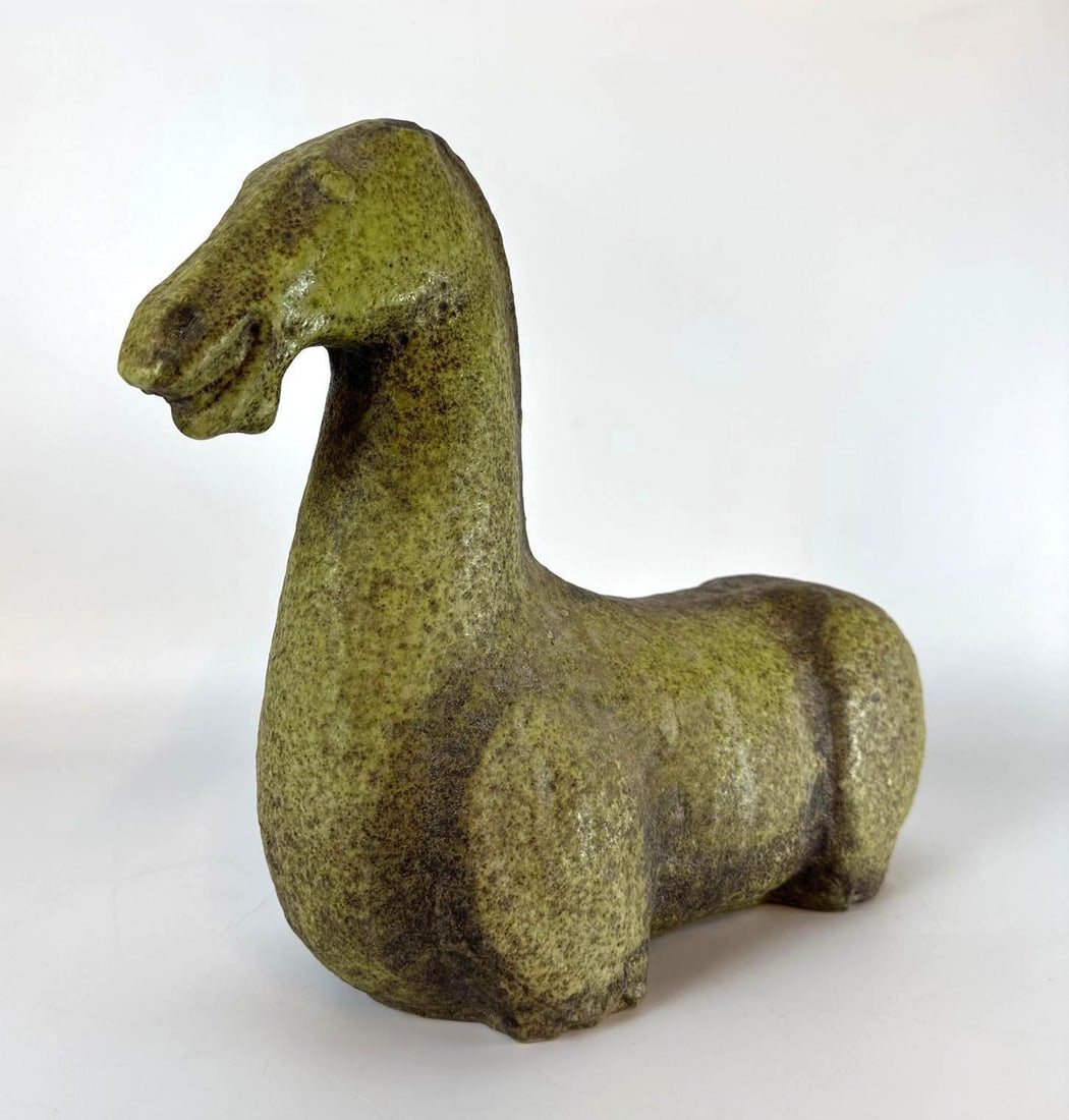 ITALIAN CERAMIC STYLIZED HORSE STATUE: An Italian glazed ceramic horse sculpture in a vibrant chartreuse green textured glaze. Approximate Dimensions: 12"H x 14.5"W x 4.5"D Artist or Maker: Unknown Provenance: From a New York C