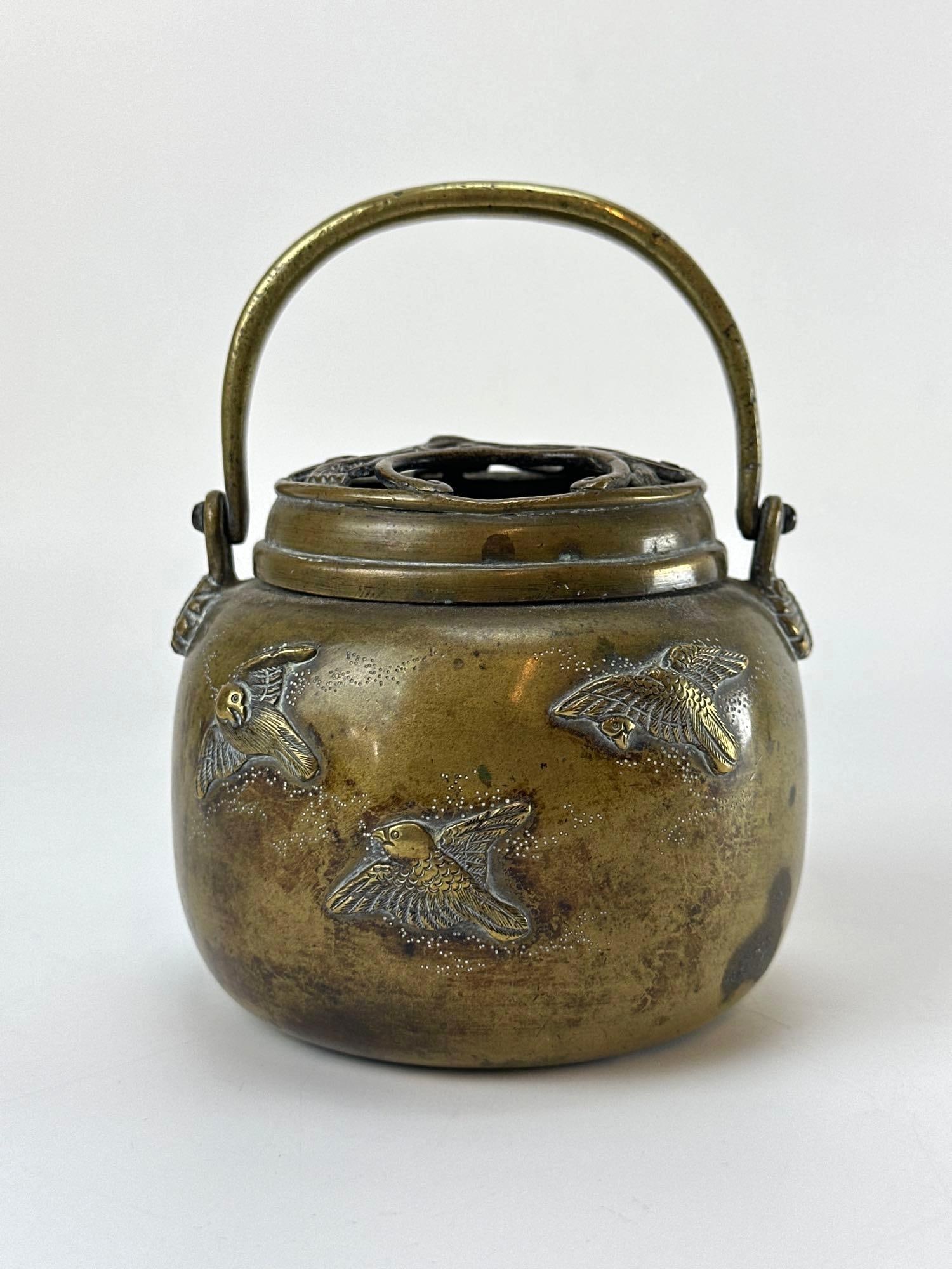 ANTIQUE JAPANESE MEIJI PERIOD BRONZE KORO INCENSE BURNER: Globular bronze vessel with relief-decorated birds in flight and a pierced openwork scrollwork lid. Approximate Dimensions: 4”H x 4.5" Dia Artist or Maker: Indecipherable Provenance: From a 