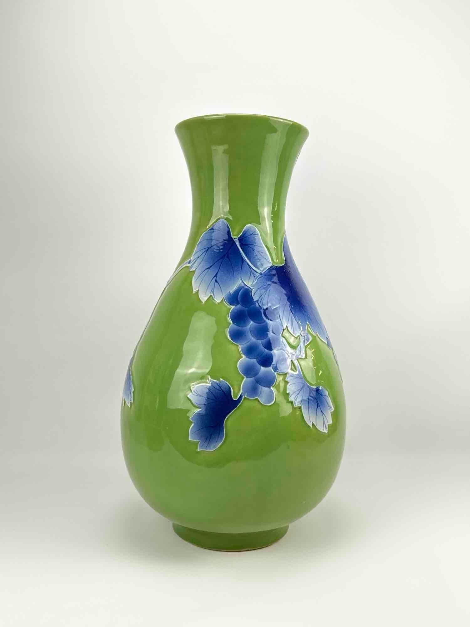 TWO FOOT TALL JAPANESE ANDO CLOISONNE LIME GREEN AND BLUE ENAMEL VASE: Large-scale Japanese floor vase with a vibrant lime green glaze decorated with blue relief-style grape clusters and vine leaves. Approximate Dimensions: 23.5”h x 12.5”dia Artist or Maker: 