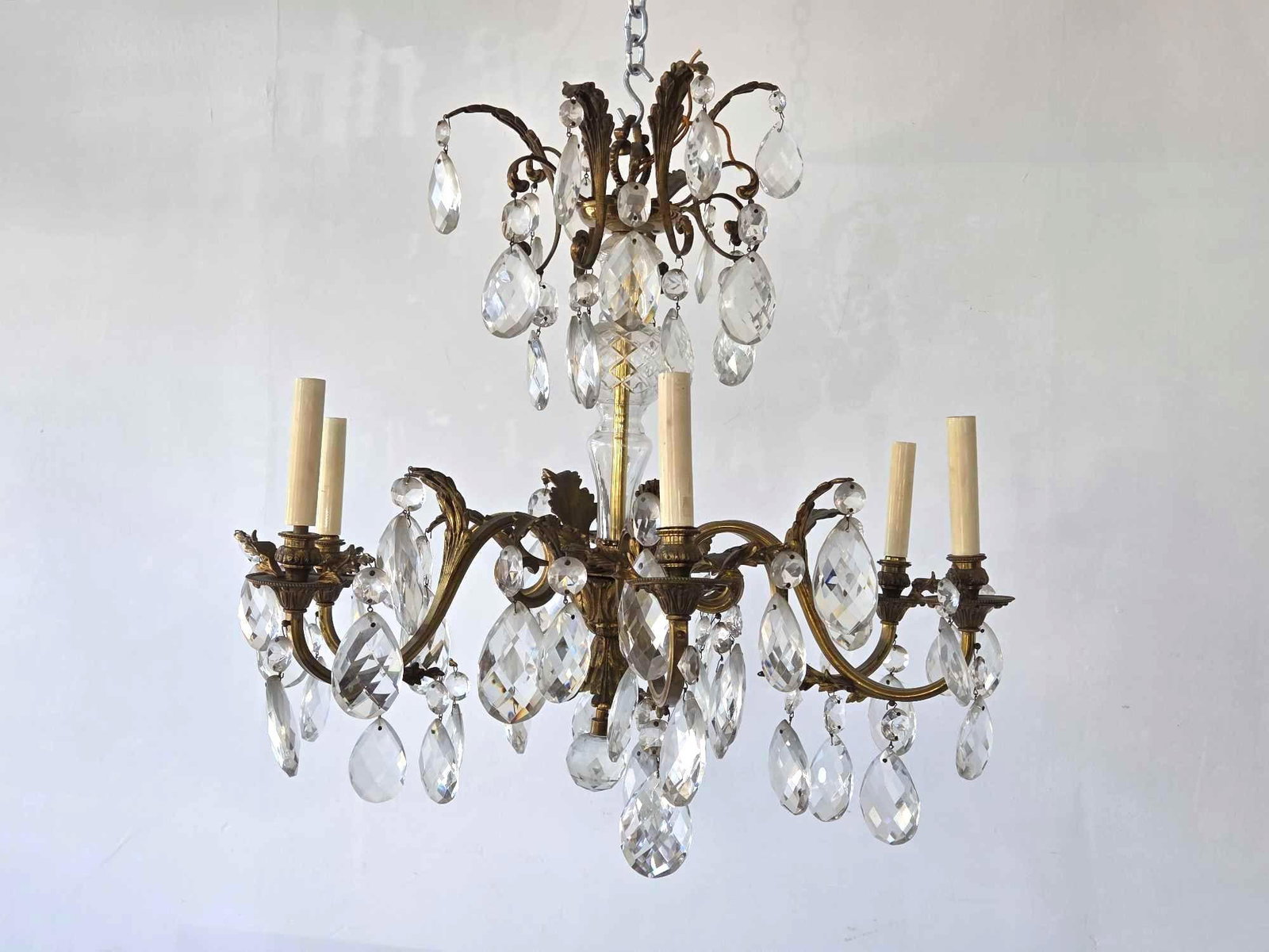 BRONZE AND CZECHOSLOVAKIAN CRYSTAL SIX LIGHT CHANDELIER: A two-tiered classical bronze light fixture with large faceted crystal drops and six candle-style arms. Approximate Dimensions: 23"H x 24"Dia Artist or Maker: Unknown Provenance: From a New Yo