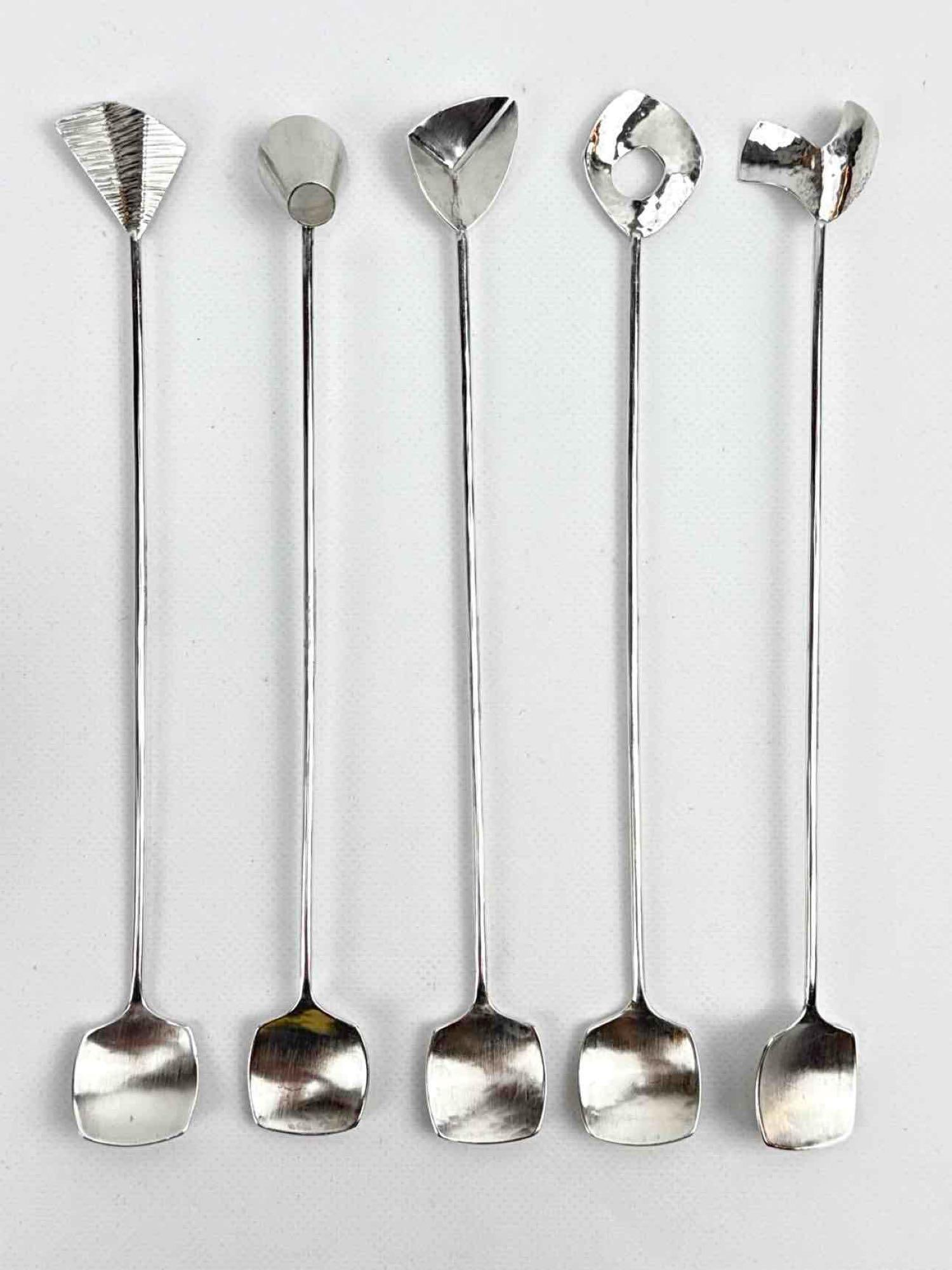 SET OF 5 ODELL STERLING SILVER MODERNIST COCKTAIL STIRRERS: Five handcrafted sterling silver bar spoons with unique geometric and organic finials and hammered details. Approximate Dimensions: 8" X 1" Approximate Weight: 2.710 ozt Maker: Odell Provenanc