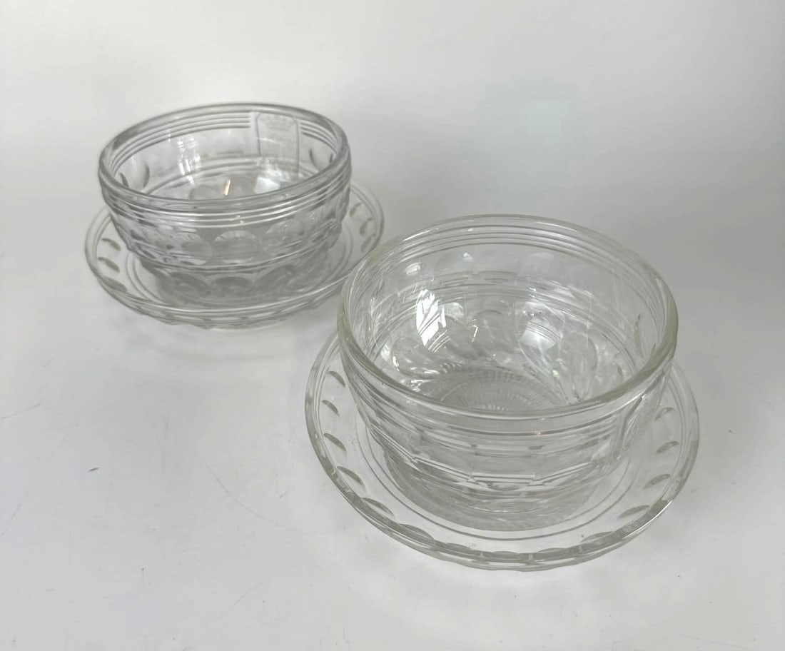PAIR OF ANTIQUE ANGLO-IRISH CUT CRYSTAL BOWLS AND MATCHING UNDERPLATES: Two antique clear cut crystal deep finger bowls with matching underplates. Approximate Dimensions: 4” x 6” x 6” Artist or Maker: Unknown Provenance: From a New York Collector No