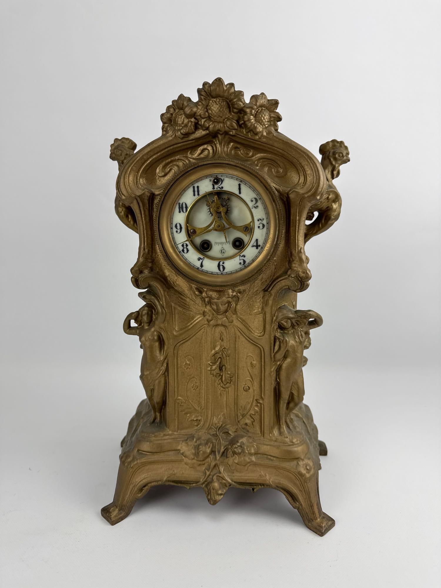 ART NOUVEAU MANTEL CLOCK: An antique, American bronze mantel clock with ornate sunflowers, chickens and figures within the design. Approximate Dimensions: 11” x 6” x 15”H Artist or Maker: Unknown Provenance: 