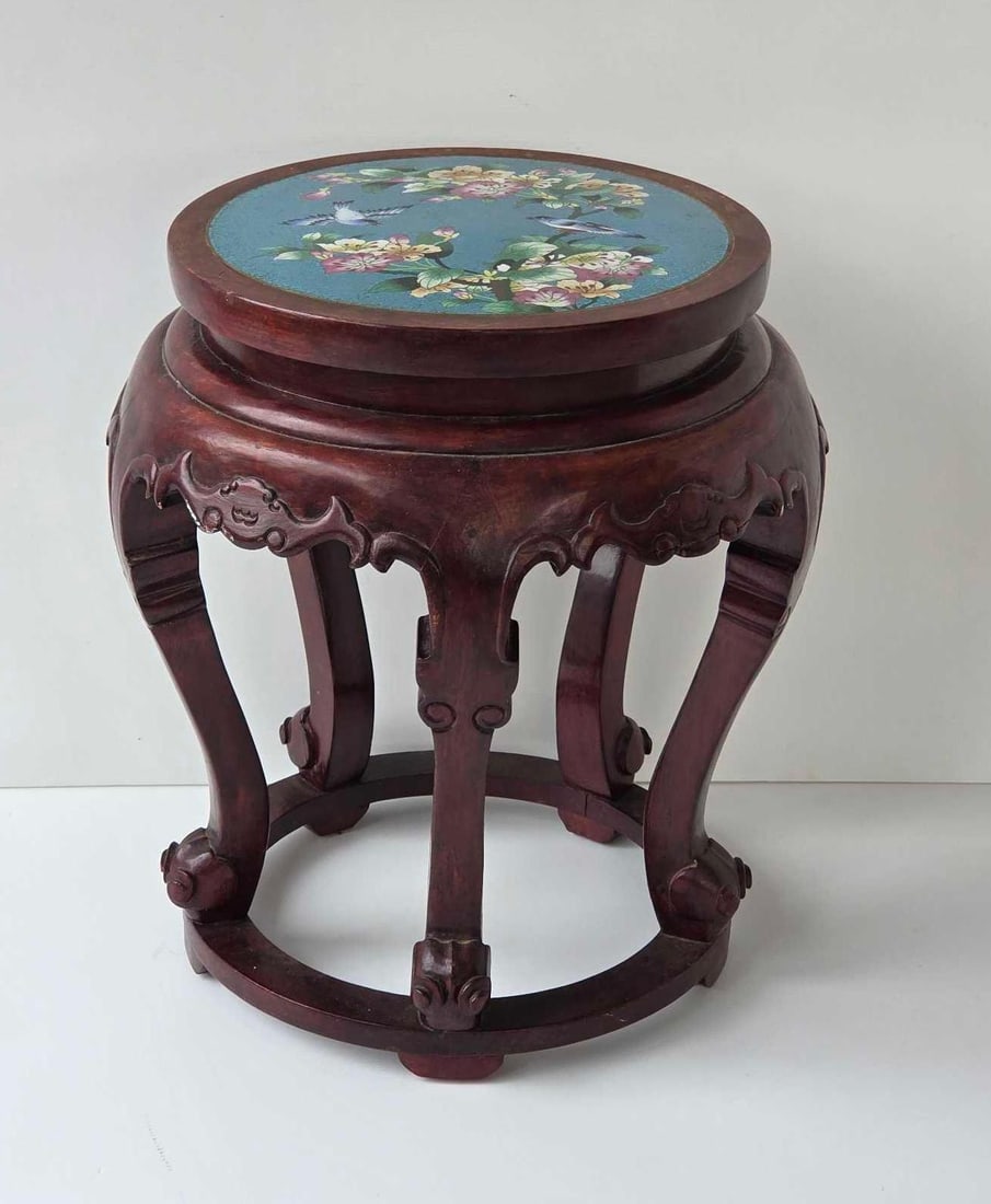 CHINESE CARVED WOOD TABOURET WITH CLOISONNE INSET TOP: Traditional dark-toned hardwood circular garden seat with five cabriole legs, carved floral aprons, and a turquoise-ground cloisonné medallion depicting birds and cherry blossoms. Approximate Dimensi