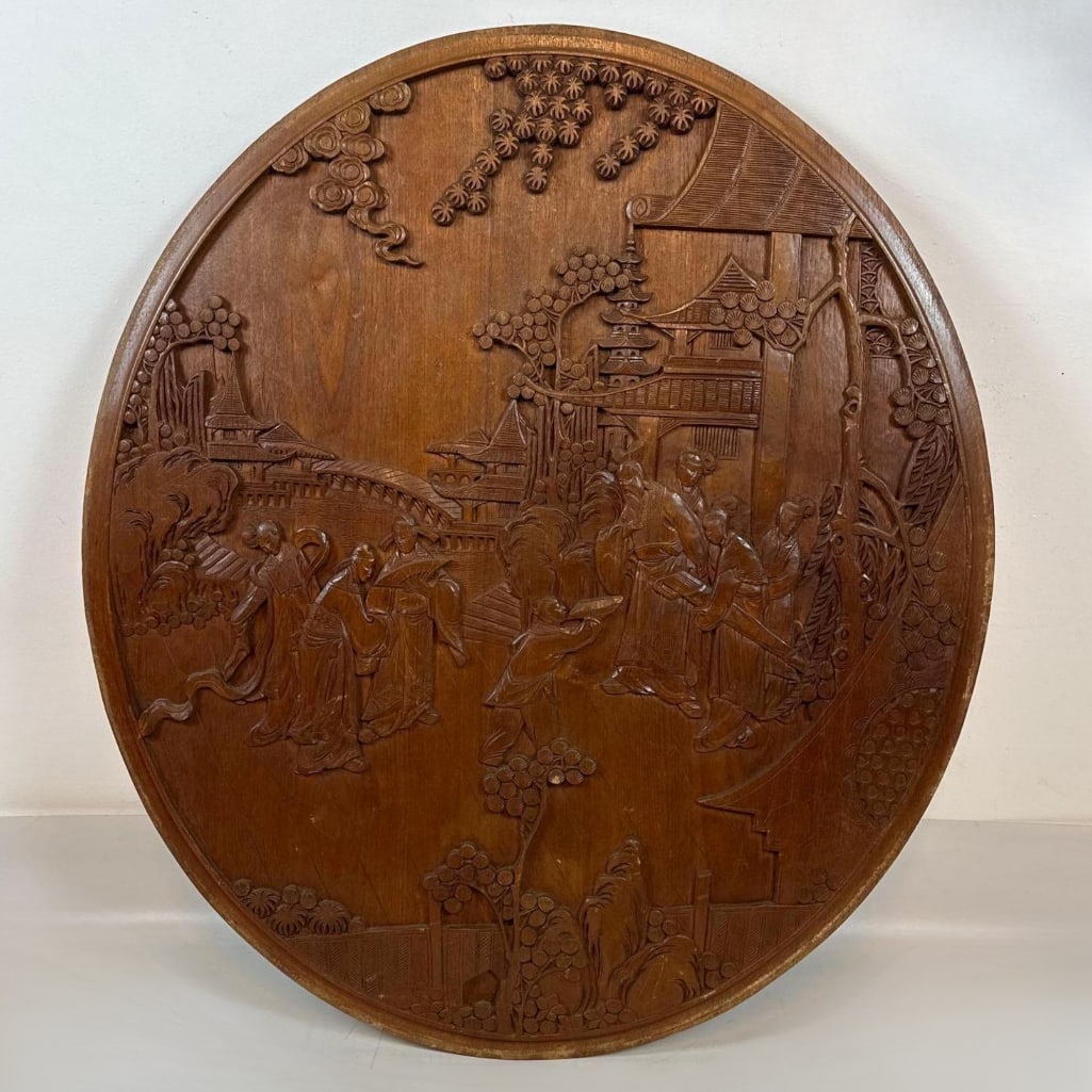 WOOD LARGE CHINESE HAND CARVED ROUND FIGURAL WALL PLAQUE: Large circular hand-carved relief panel in camphor wood depicting a traditional village scene. Approximate Dimensions: 33' x 39'' Artist or Maker: Unknown Provenance