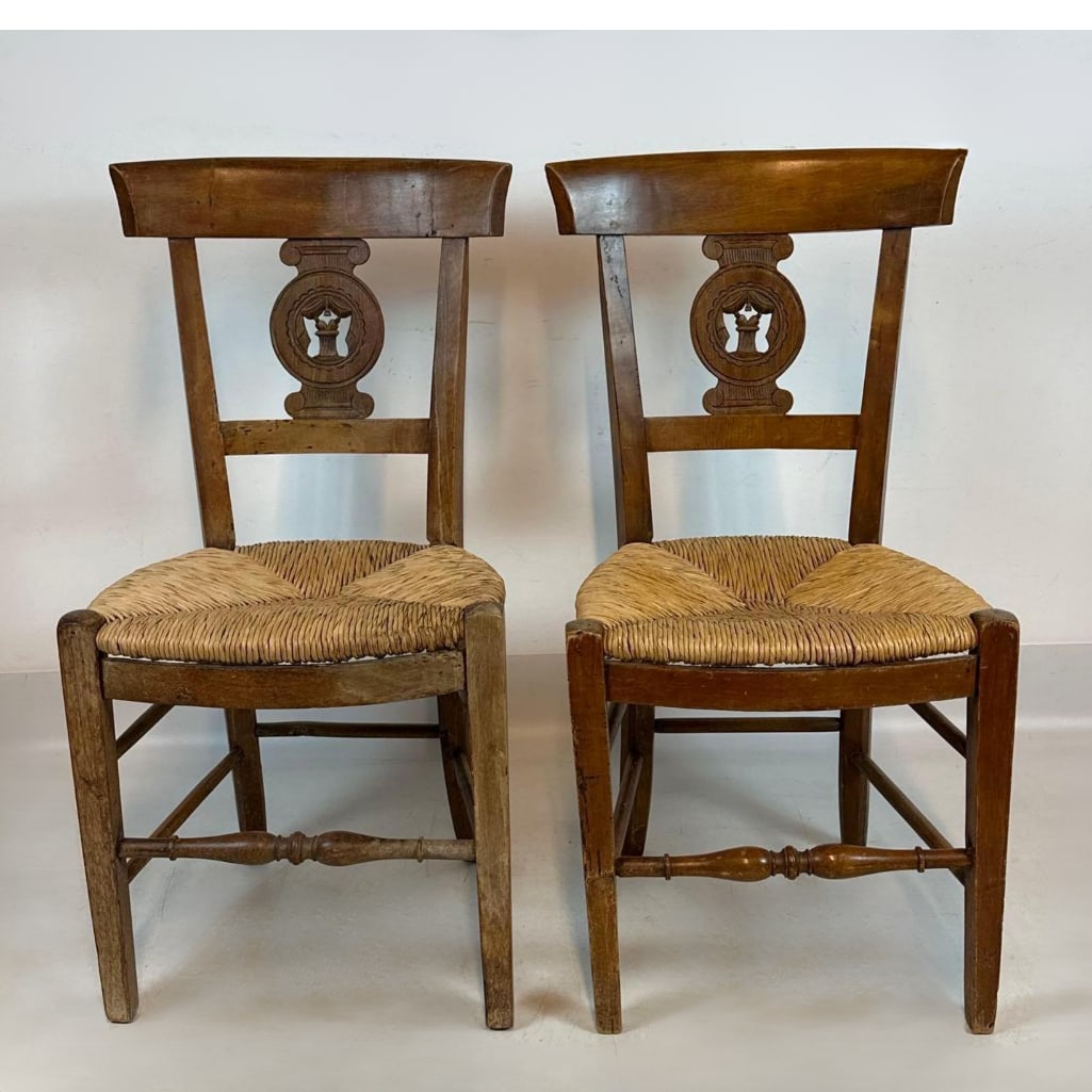 PAIR OF FRENCH PROVINCIAL CARVED RUSH SEAT SIDE CHAIRS: Set of two traditional Provençal hardwood dining chairs with hand-woven rush seats. Approximate Dimensions: Dimensions: 17”x15”x34” Artist or Maker: Unknown Provenan