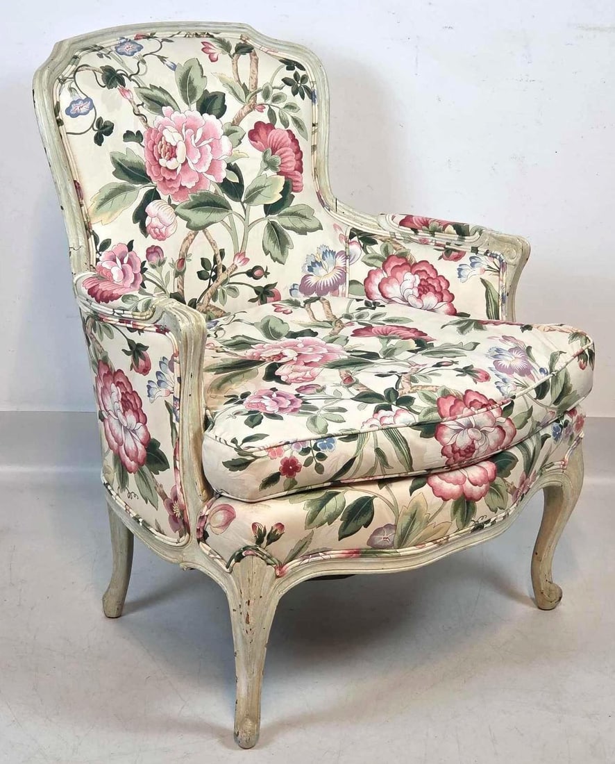 VALUE LOT LOUIS XV STYLE CARVED AND PAINTED BERGERE CHAIR: A deep-seated upholstered armchair with a distressed cream painted wood frame and colorful floral motif fabric. Approximate Dimensions: 34"H x 28"W x 28"D Artist or Maker: Unknown Provenan