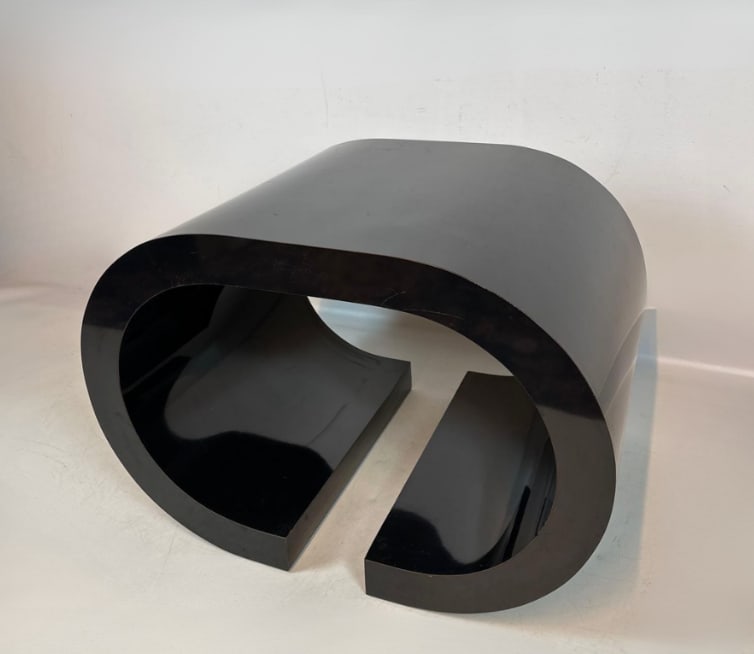 POST-MODERN STYLE BLACK LAMINATE SCROLL COFFEE TABLE: A post-modern style black formica low coffee table with a molded c-scroll double-return form. ApproximateÂ Dimensions: 30â€x22â€x21â€