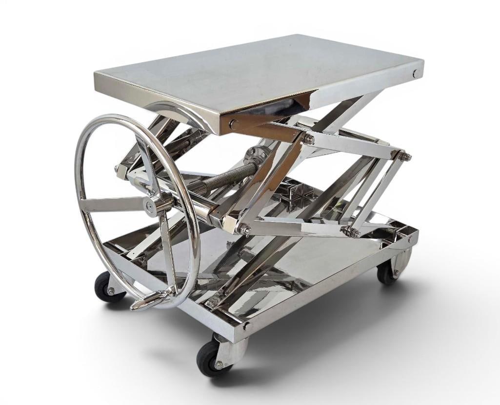 RESTORATION HARDWARE INDUSTRIAL CHROME METAL SCISSOR LIFT LOW COFFEE TABLE RAISED ON CASTER WHEELS: Restoration Hardware Industrial chrome metal scissor lift low coffee table raised on caster wheels and powered by a large wheel to lift or lower. Very heavy and well made. Approximate Dimensions: