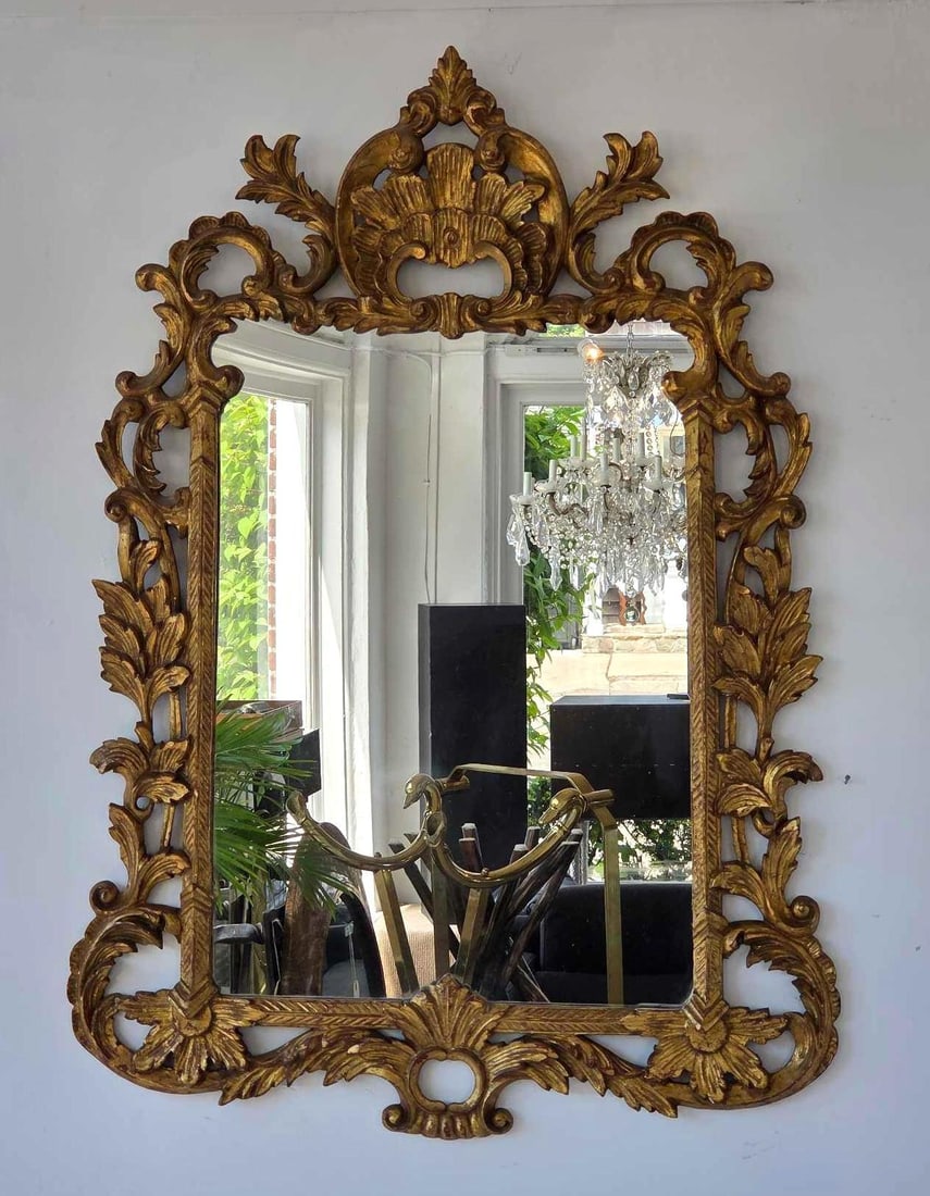 ANTIQUE LA BARGE STYLE ITALIAN ROCOCO STYLE CARVED GILTWOOD WALL MIRROR: Ornate vertical wall mirror with an intensively carved openwork giltwood frame showcasing a pierced rocaille shell crest, flowing acanthus leaves, and C-scroll flourishes. Approximate Dimensions: 43&#