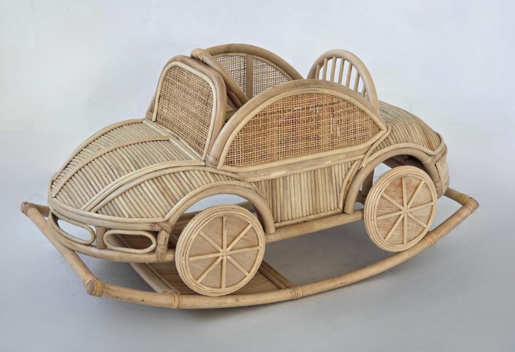 VINTAGE GABRIELLA CRESPI STYLE RATTAN VOLKSWAGEN BEETLE CHILD'S ROCKER: Handmade bent rattan and woven cane children's rocking toy sculpted in the form of a vintage Volkswagen Beetle automobile with integrated runners and wood-spoked wheels. Approximate Dimensions: