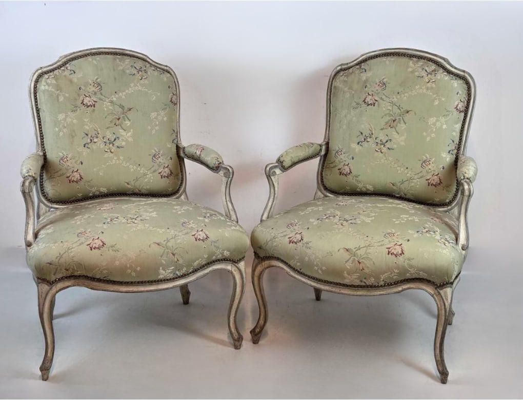 PAIR OF FRENCH LOUIS XV STYLE PAINT DECORATED FAUTEUILS: Pair of provincial French Louis XV style open armchairs with distressed sage green and cream painted frames upholstered in a floral brocade fabric with nailhead trim. Approximate Dimensions: 38.25"