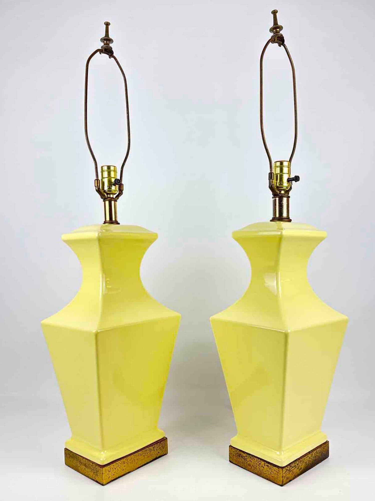 PAIR OF VINTAGE STIFFEL STYLE YELLOW CERAMIC BALUSTER TABLE LAMPS: Pair of mid-century modern architectural table lamps with glossy pale yellow glazed ceramic bodies in a faceted baluster form mounted on square gilt-speckled wooden bases. Approximate Dimensions: 23&r